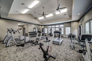 A gym with treadmills and other exercise equipment at the enclave at university crossings